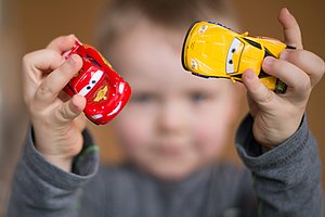 Foto von Kinderhänden mit Spielzeugautos