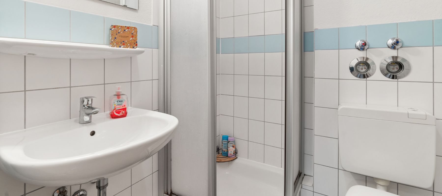 Foto vom Bad im Einzelapartment. Zu sehen sind Waschbecken, Toilette und Dusche.